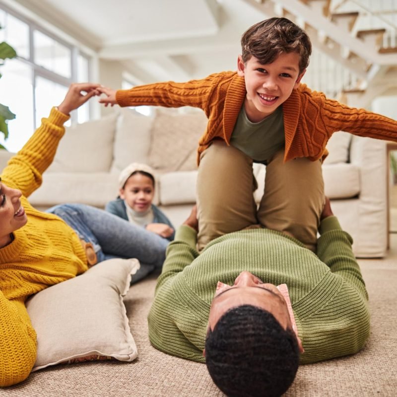 Parents enjoying joyful moments with their kids at home, protected with dependable renters insurance.