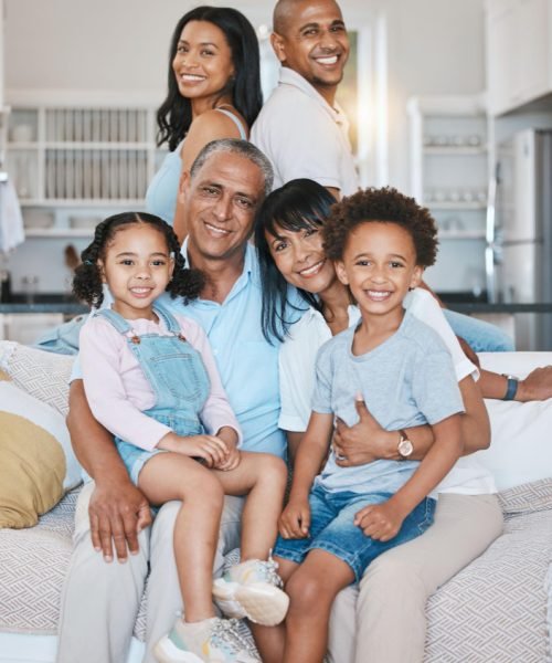 Large diverse family smiling on their rented property covered by renters insurance.